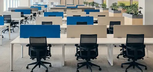 Modern open-plan office space featuring clean workstations, ergonomic chairs, and sanitized carpets provided by professional office cleaning services in Marietta, GA.