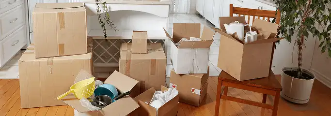 Packed moving boxes and household items in a kitchen before move-out or move-in cleaning, Marietta, GA.